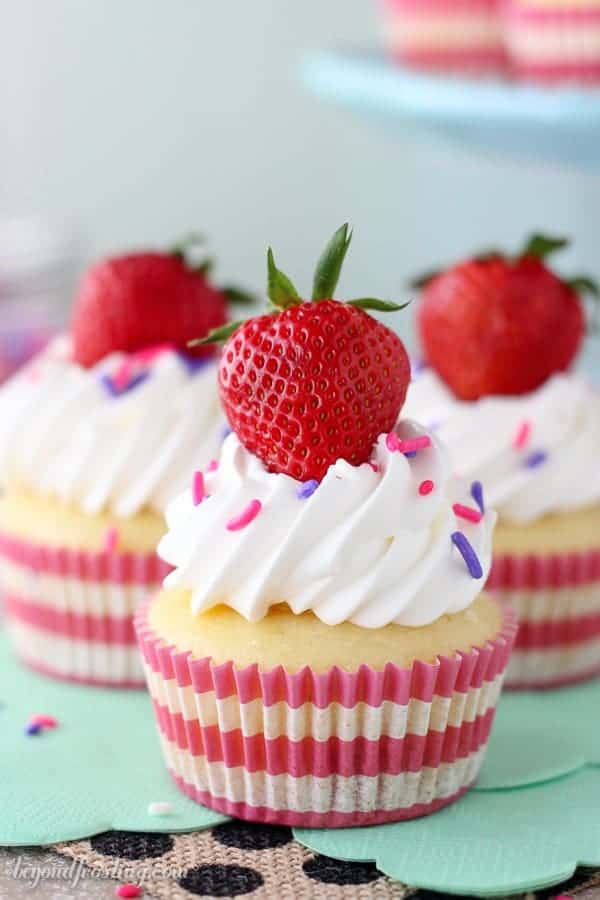 Take a big bite out of these Easy Strawberry and Cream Cupcakes! The strawberry cupcake are filled with a lightened up mousse and topped with whipped cream.