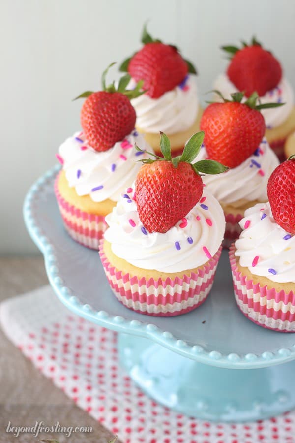 These Easy Strawberry and Cream Cupcakes are so refreshing. The strawberry cupcakes are filled with a light and airy mousse, and topped with whipped cream and more strawberries