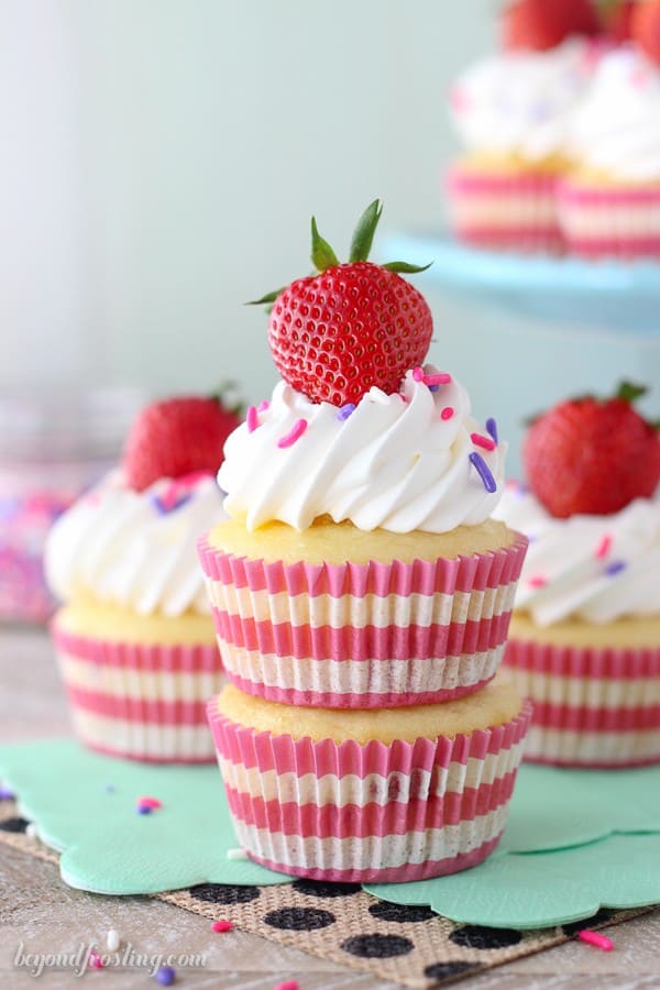 Quick and easy Strawberry and Cream Cupcakes. The vanilla cupcakes are sweetened with strawberries, a vanilla mousse and a whipped cream topping.