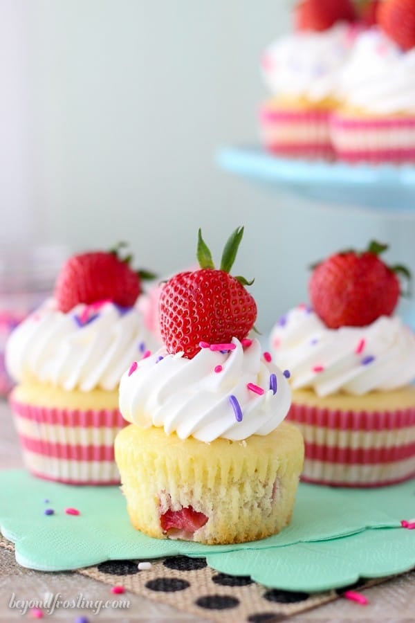 Take a big bite out of these Easy Strawberry and Cream Cupcakes! The strawberry cupcake are filled with a lightened up mousse and topped with whipped cream.