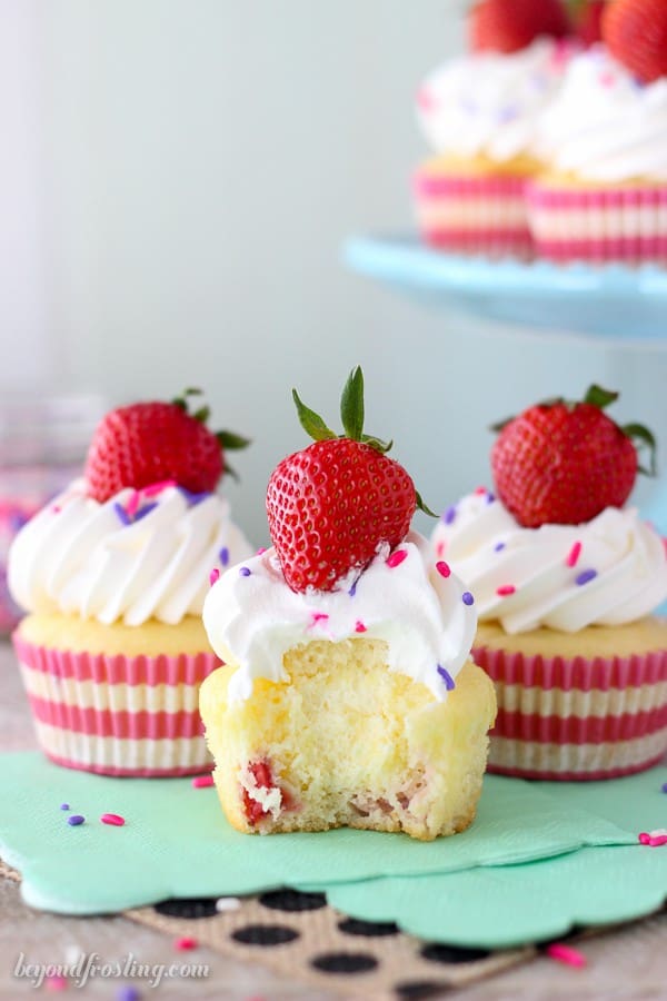 Take a big bite out of these Easy Strawberry and Cream Cupcakes! The strawberry cupcake are filled with a lightened up mousse and topped with whipped cream.