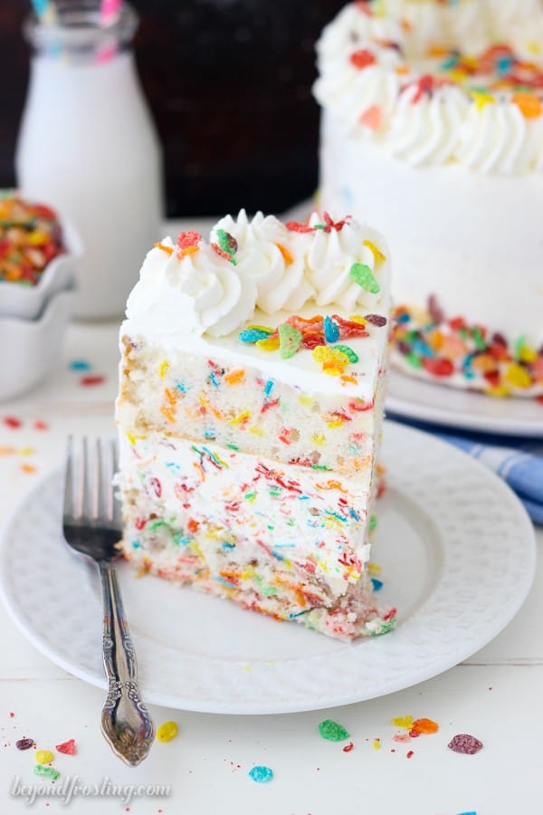 A Piece of Fruity Pebble Ice Cream Cake on a Plate with a Fork