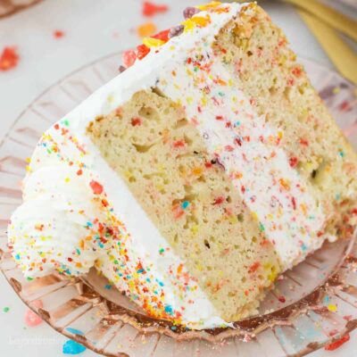 Angled view of a slice of fruity pebble ice cream cake