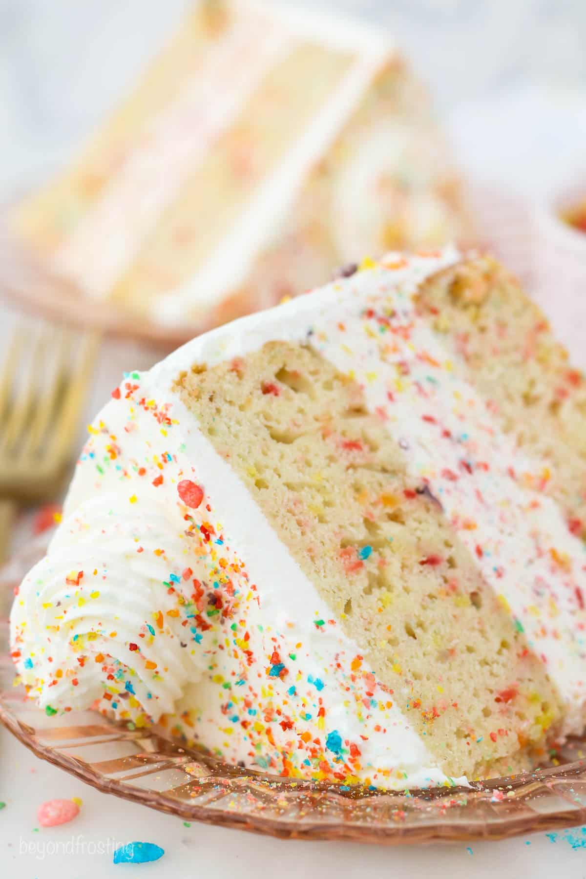 A slice of fruity pebble ice cream cake on a plate