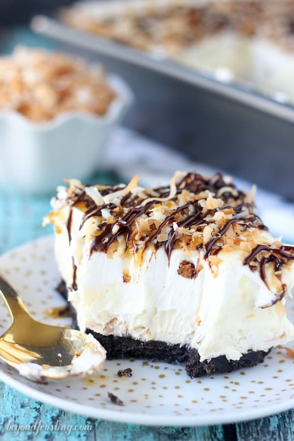 Take your Samoa icebox cake to the next level with this No-Bake Samoa Lush. Samoa lush is an Oreo cookie crust, a layer of caramel cheesecake, coconut mousse and a whipped cream topped with caramel, hot fudge and toasted coconut