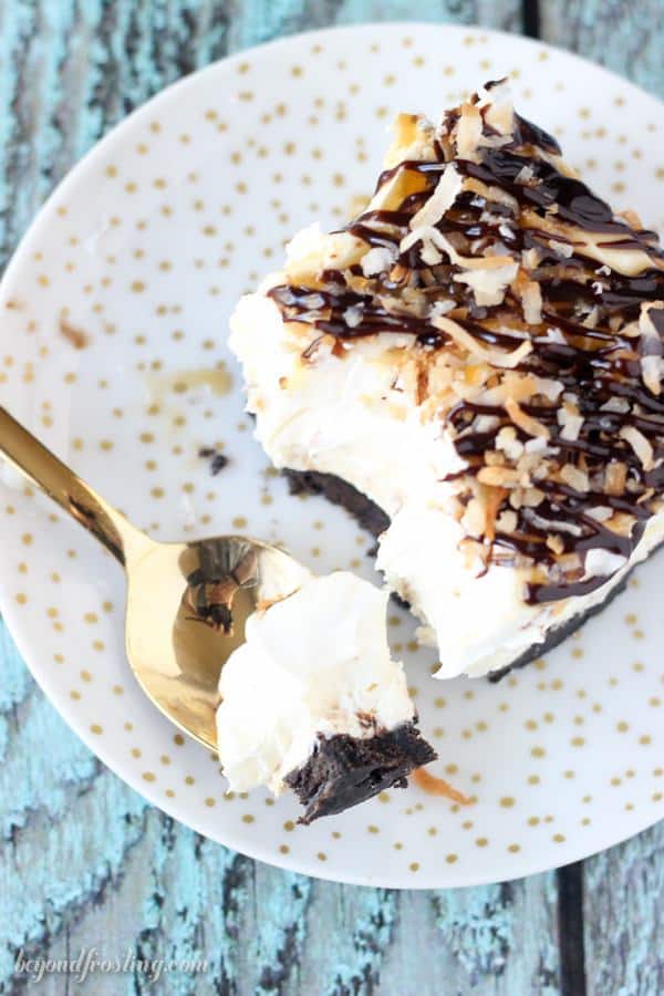 Take your Samoa icebox cake to the next level with this No-Bake Samoa Lush. Samoa lush is an Oreo cookie crust, a layer of caramel cheesecake, coconut mousse and a whipped cream topped with caramel, hot fudge and toasted coconut