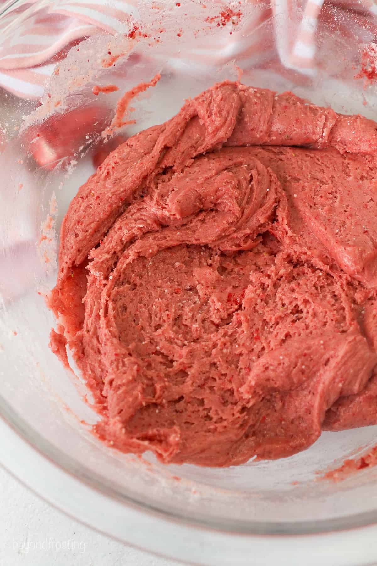 Strawberry cookie dough in a glass mixing bowl.