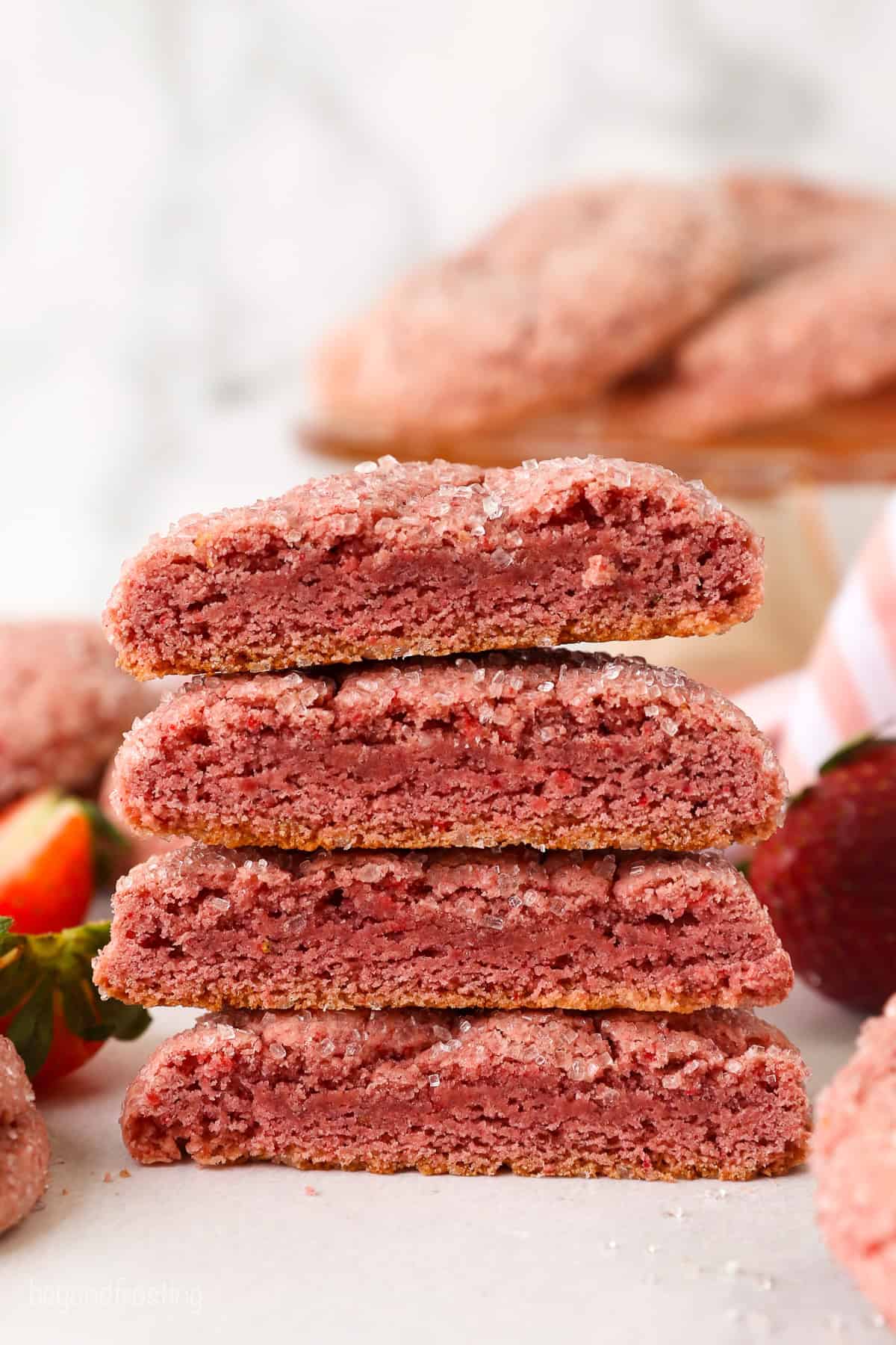 A stack of four strawberry cake mix cookies, cut in half.