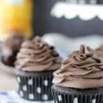 These cake mix Kahlua cupcakes are extra chocolatey, loaded with Kahlua and topped with an espresso infused with frosting. A few of them are lined up in this image.