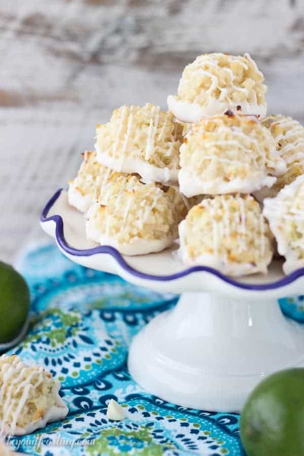 Quick and easy white chocolate coated Coconut Lime Macaroons. Just 7 simple ingredients, these come together in less than 10 minutes. The fresh lime zest is the perfect compliment to this recipe. This is from the cookbook, Out Of The Box Desserts. It is a must-have!