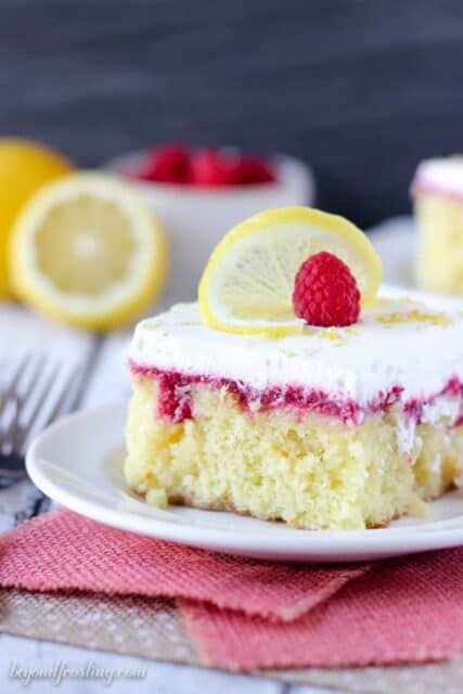 This Lemon Raspberry Poke Cake is an easy lemon cake soaked in sweetened condensed milk, with a fresh raspberry sauce and topped with whipped cream.