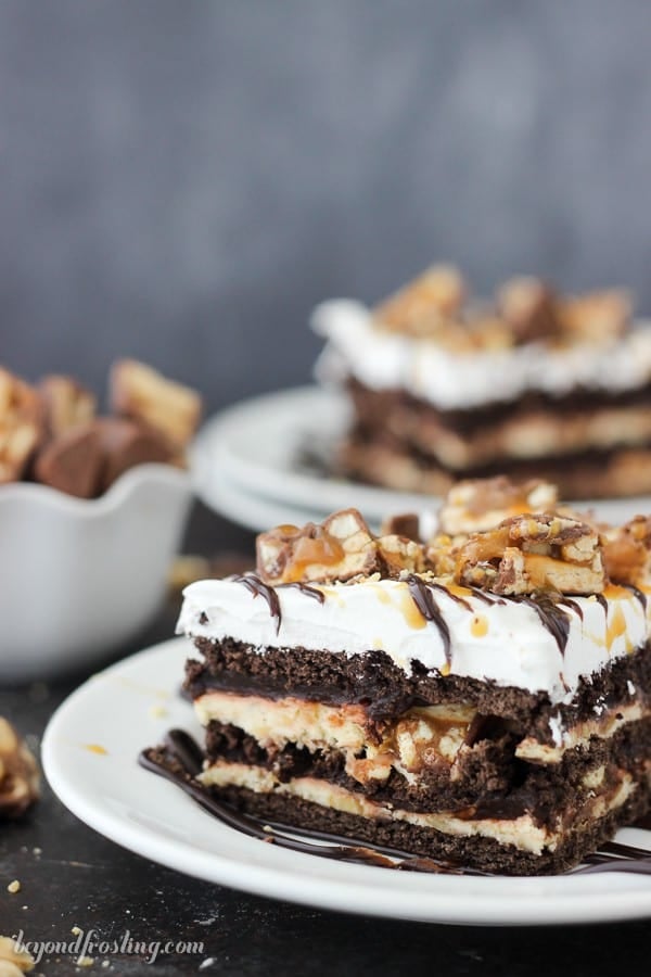 Give your oven a break this summer with this No-Bake Snickers Icebox Cake. Lots of chocolate, caramel and salty peanuts to go around. This easy layer cake has chocolate graham crackers, caramel cream cheese, chocolate pudding and Cool Whip.