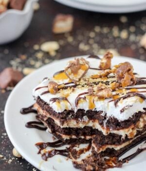 Give your oven a break this summer with this No-Bake Snickers Icebox Cake. Lots of chocolate, caramel and salty peanuts to go around. This easy layer cake has chocolate graham crackers, caramel cream cheese, chocolate pudding and Cool Whip.
