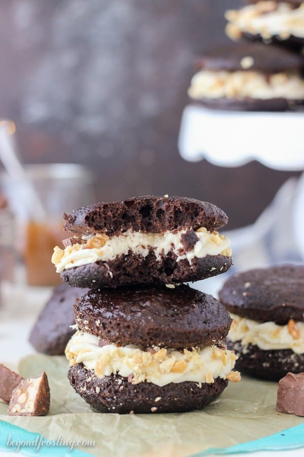 These Snickers Whoopie Pies are like mini Snickers cakes. The caramel buttercream is sandwiched between two chocolate cakes and it's rolled in salty peanuts. Plus you've got the chopped up Snickers bars in the middle!
