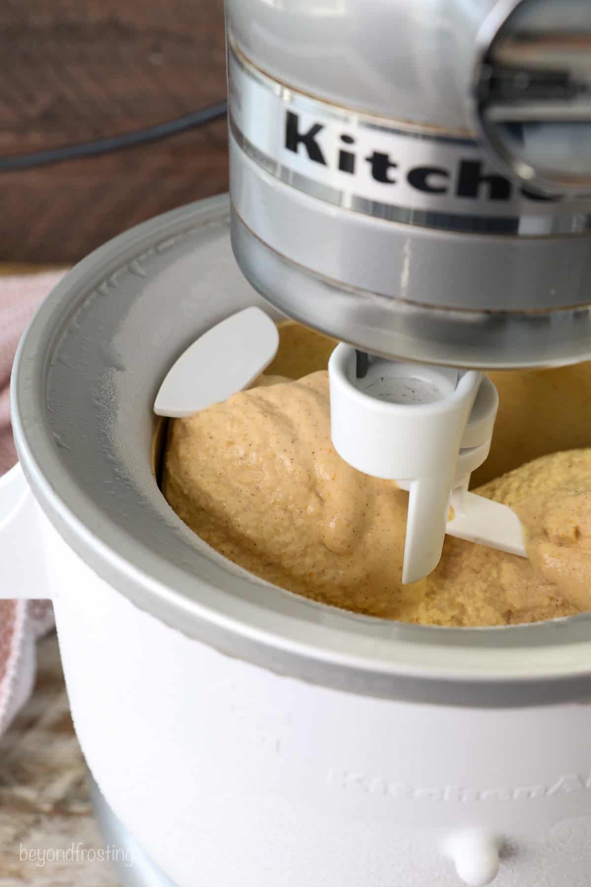 Close up of pumpkin ice cream churning inside the ice cream maker.