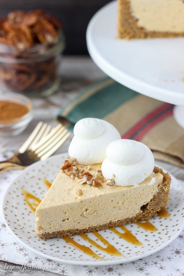 A slice of no-bake pumpkin cheesecake with nuts and whipped cream