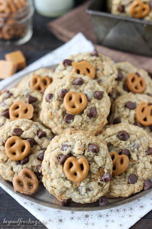 These chunky Oatmeal Salted Caramel Pretzel Cookies are filled with chopped pretzels, chocolate chips, a ribbon of salted caramel and caramel covered pretzels on top.
