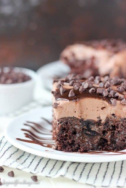 Easy & mouthwatering, this is Sinful Triple Chocolate Poke Cake. The fudgy chocolate cake is filled with hot fudge & chocolate pudding. It’s topped with a chocolate whipped cream made with hot chocolate. This is a chocolate lovers dream.