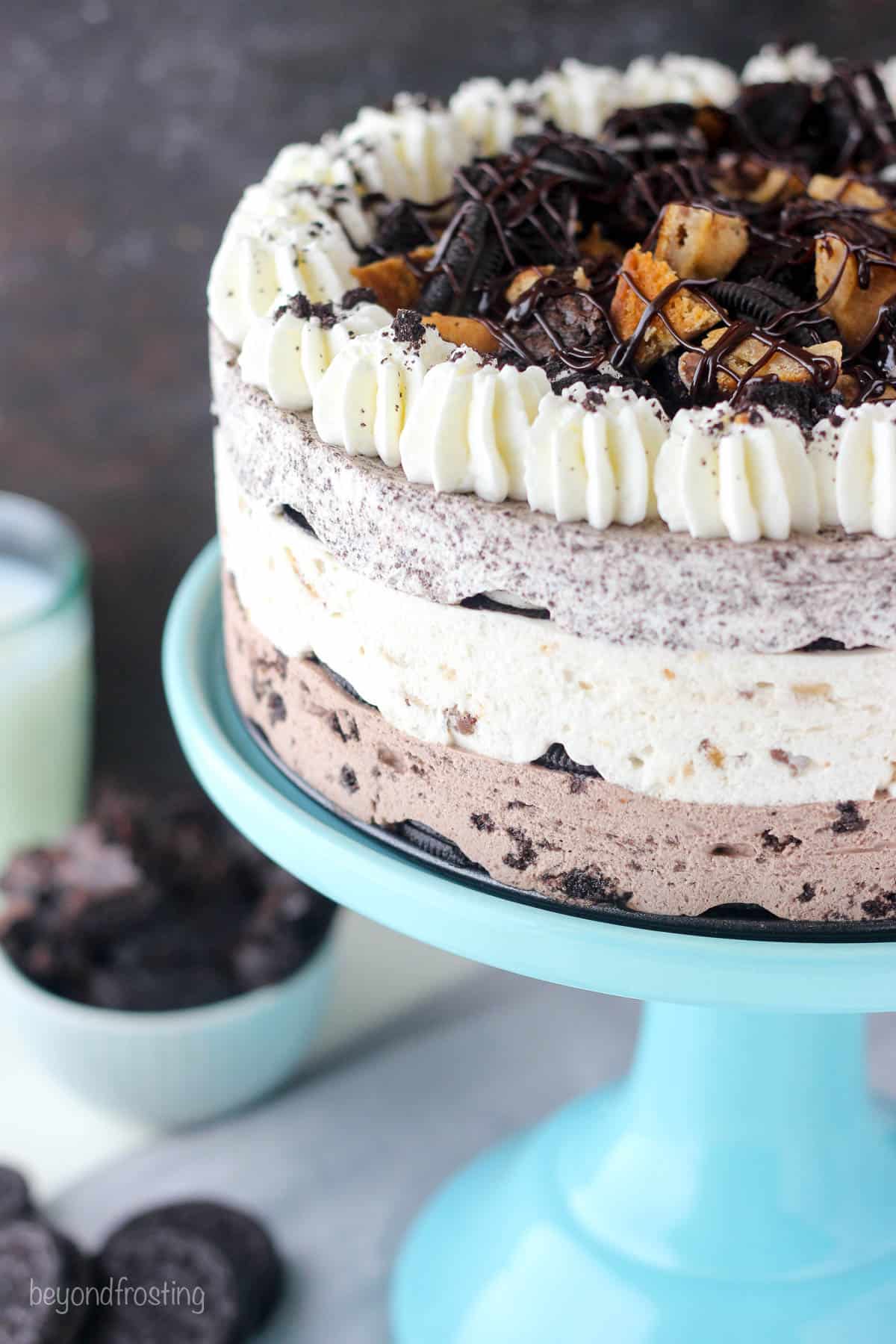 View of half an Oreo icebox cake on a plate cake stand