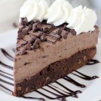 This Brownie Bottom Chocolate Mousse Cake is fudgy brownie is topped with a rich dark chocolate cream cheese mousse and whipped cream. This is the perfect dessert for your favorite chocolate lover.