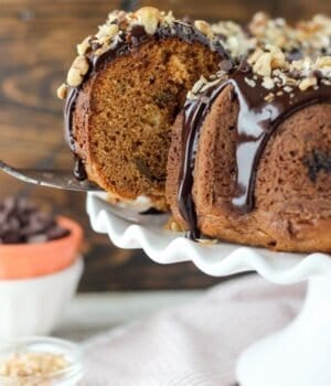 This Pumpkin Seven Layer Bundt Cake is inspired by my favorite seven layer bar, but packed into a pumpkin spice cake. The cake is stuffed with walnuts and chocolate chips and finished with a decadent chocolate ganache and shredded coconut.
