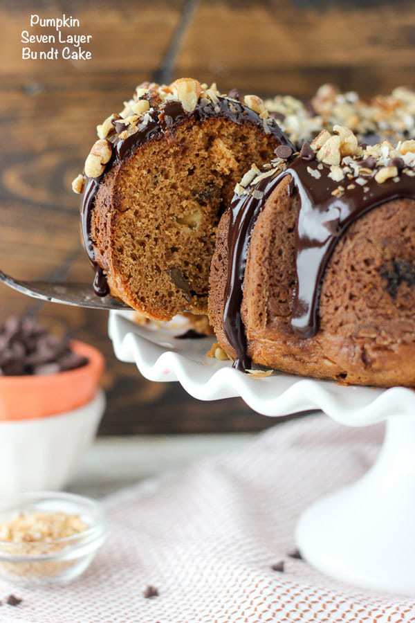 This Pumpkin Seven Layer Bundt Cake is inspired by my favorite seven layer bar, but packed into a pumpkin spice cake. The cake is stuffed with walnuts and chocolate chips and finished with a decadent chocolate ganache and shredded coconut.