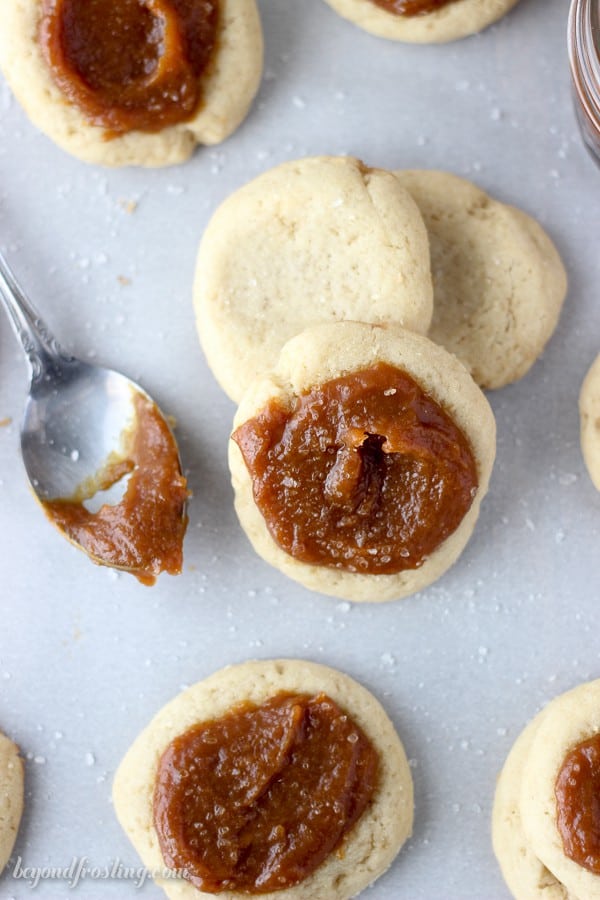 These Salted Pumpkin Caramel Cookies are a soft buttery thumbprint cookie filled with a homemade salted pumpkin caramel filling.