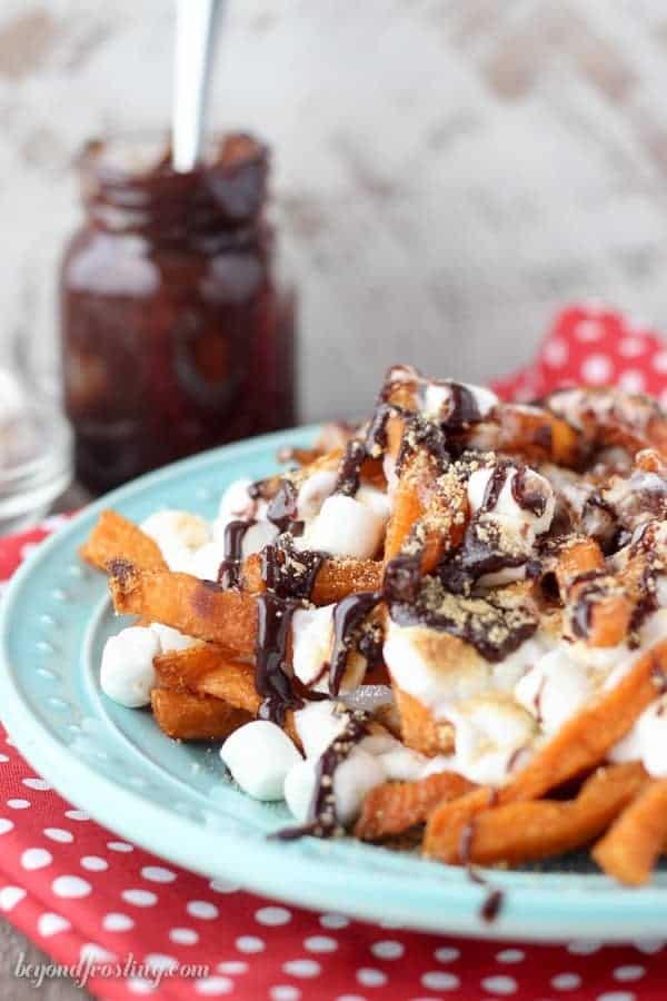 Ooey Gooey Sweet Potato S’mores Fries. Layers of crispy sweet potato fries & melted marshmallow drizzled with chocolate and crushed graham crackers. This sweet potato dessert is perfect for your next party!