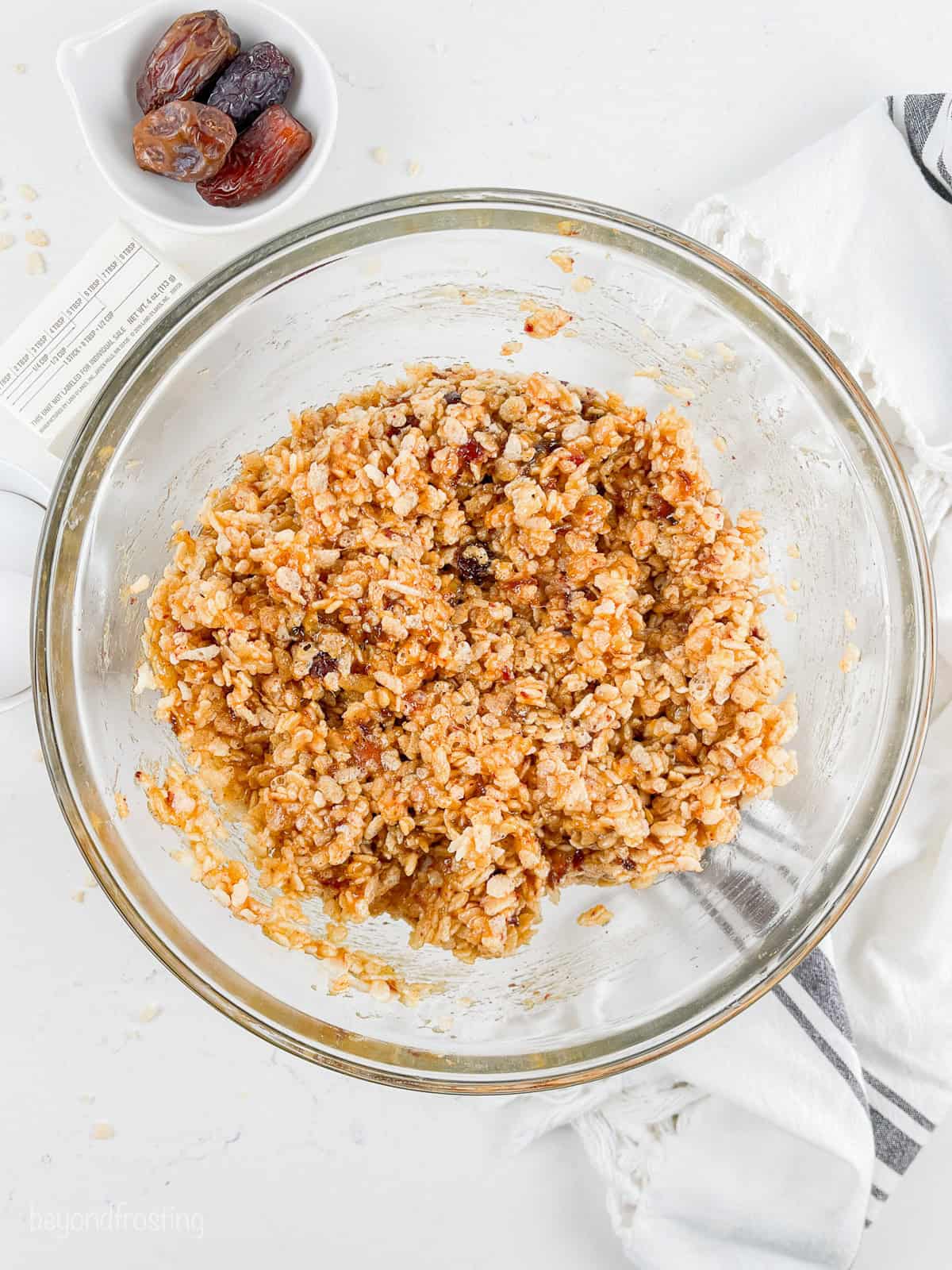 Rice Krispies and the warm date mixture combined in a glass bowl.