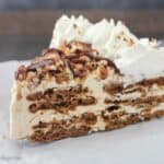 You can’t go wrong with this No-Bake Gingersnap Icebox Cake. This is a slice of gingersnap icebox cake: layers of gingersnap cookies and a molasses mousse. This dessert is topped off with plenty of caramel, hot fudge and pecans.