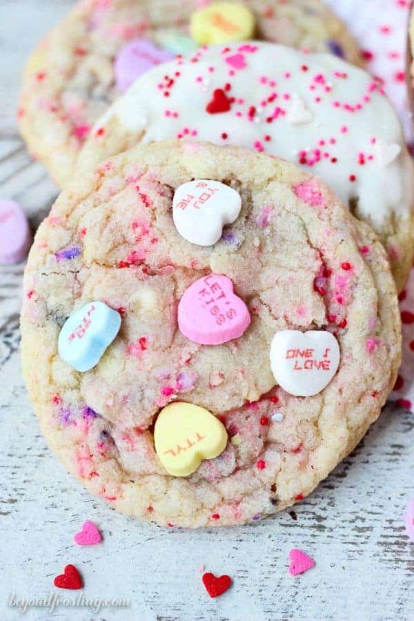 Tell someone you love them with these Conversation Heart Sugar Cookies. These buttery sugar cookies are filled with little pops of sweetness with crushed candy hearts and sprinkles.