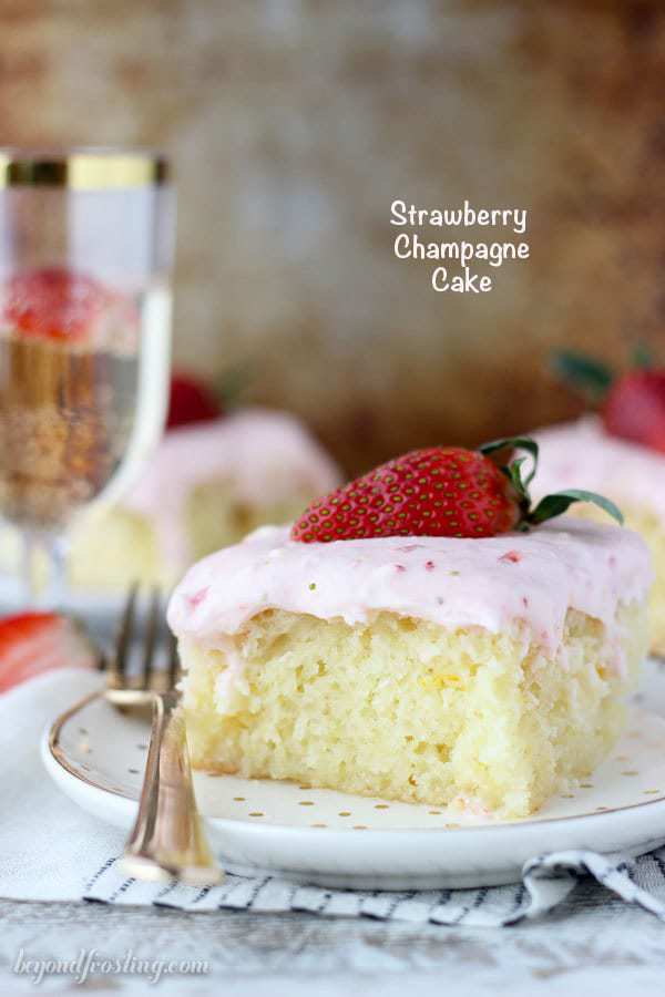 This Strawberry Champagne Cake is an orange infused vanilla cake soaked in a champagne glaze and topped with a tangy strawberry cream cheese frosting.