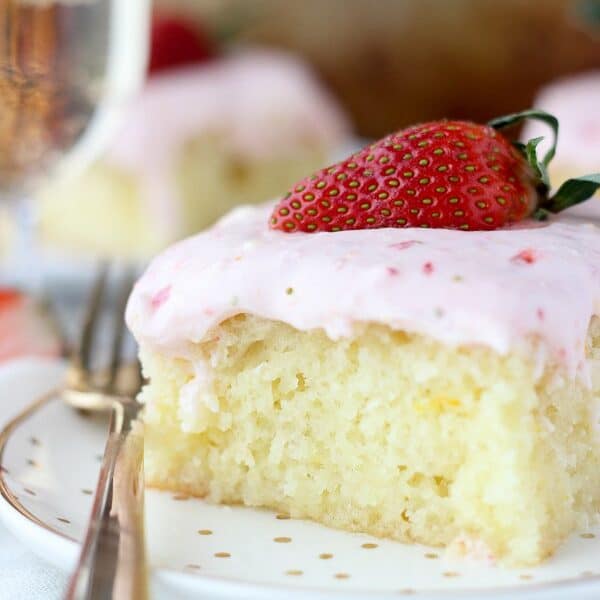 An orange infused champagne cake soaked in a buttery champagne glaze and topped with a strawberry cream cheese frosting. You’ll be asking for seconds with this Strawberry Champagne Cake.