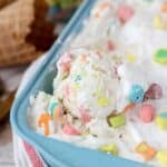 A scoop of ice cream in blue loaf pan with lucky charms marshmallow on top