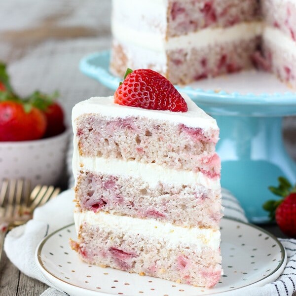 You’ll love this fresh Homemade Strawberry Cake. With three different types of strawberry flavors, this is the ultimate spring cake! It’s filled with a lemon Swiss Meringue Buttercream.