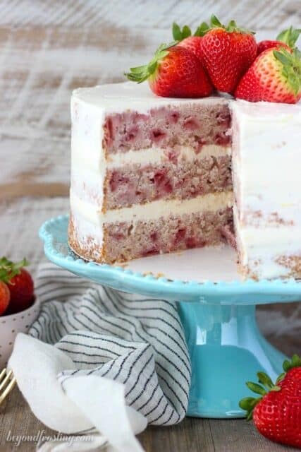 This fresh homemade Strawberry Cake is covered with a lemon Swiss Meringue Buttercream. The cake is incredibly moist and bursting with fresh strawberry flavor.