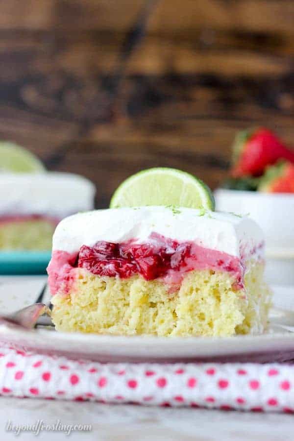 This Strawberry Margarita Cake is a lime infused, tequila-spiked cake with a layer of strawberry mousse and it’s topped with whipped cream and more lime zest.