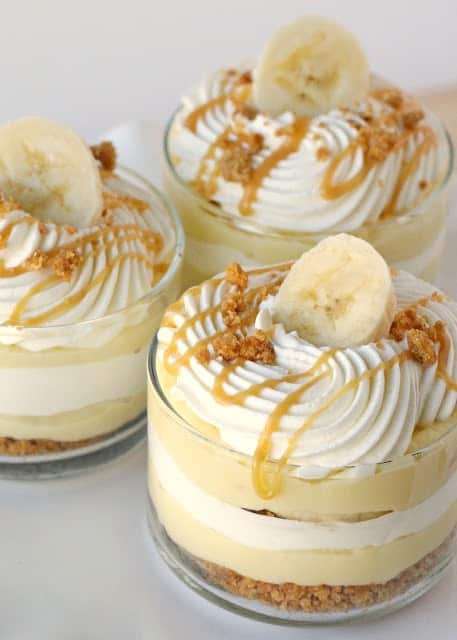 Banana Caramel Cream Dessert Parfaits Topped with Whipped Cream and a Slice of Banana