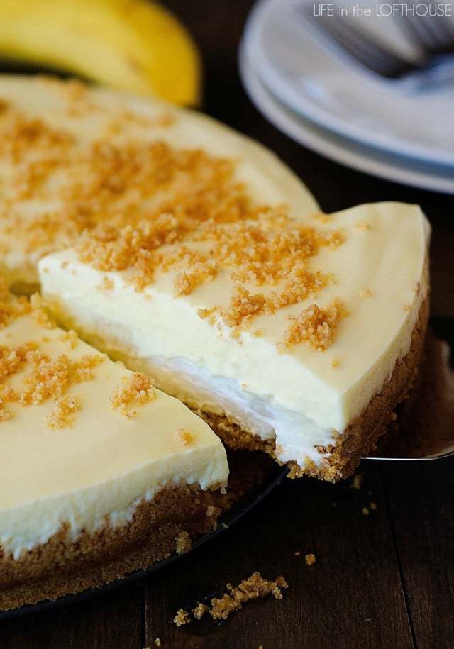 A Slice of Banana Cream Pie Cheesecake Being Lifted From the Rest of the Cake with a Dessert Spatula