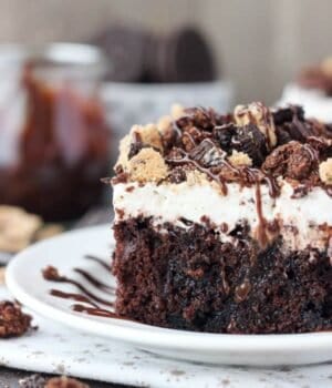 The best of all worlds, this Slutty Brookie Poke Cake is a chocolate cake filled with chocolate pudding, topped with whipped cream and crush Oreos, Brownies and Chocolate Chip Cookies. 