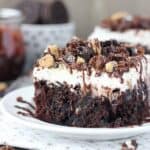 All your favorite things in one cake, this Slutty Brookie Poke Cake is a chocolate cake filled with chocolate pudding, topped with whipped cream and crush Oreos, Brownies and Chocolate Chip Cookies. 
