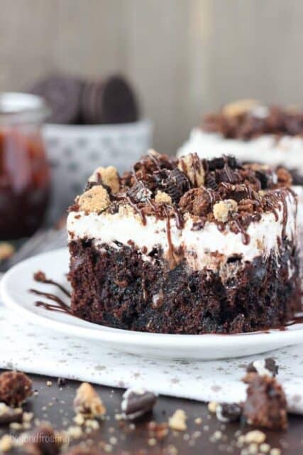 All your favorite things in one cake, this Slutty Brookie Poke Cake is a chocolate cake filled with chocolate pudding, topped with whipped cream and crush Oreos, Brownies and Chocolate Chip Cookies. 