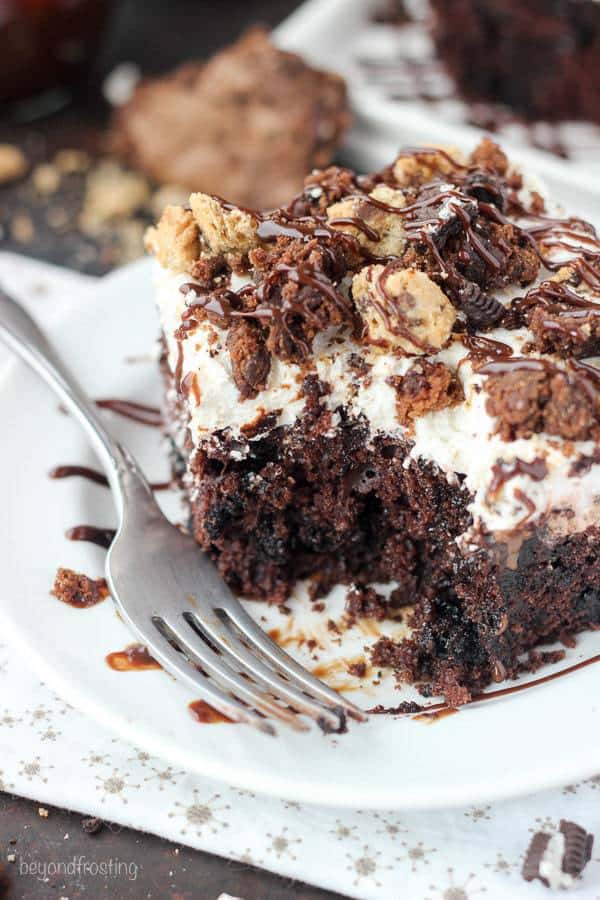The best of all worlds, this Slutty Brookie Poke Cake is a chocolate cake filled with chocolate pudding, topped with whipped cream and crush Oreos, Brownies and Chocolate Chip Cookies. 
