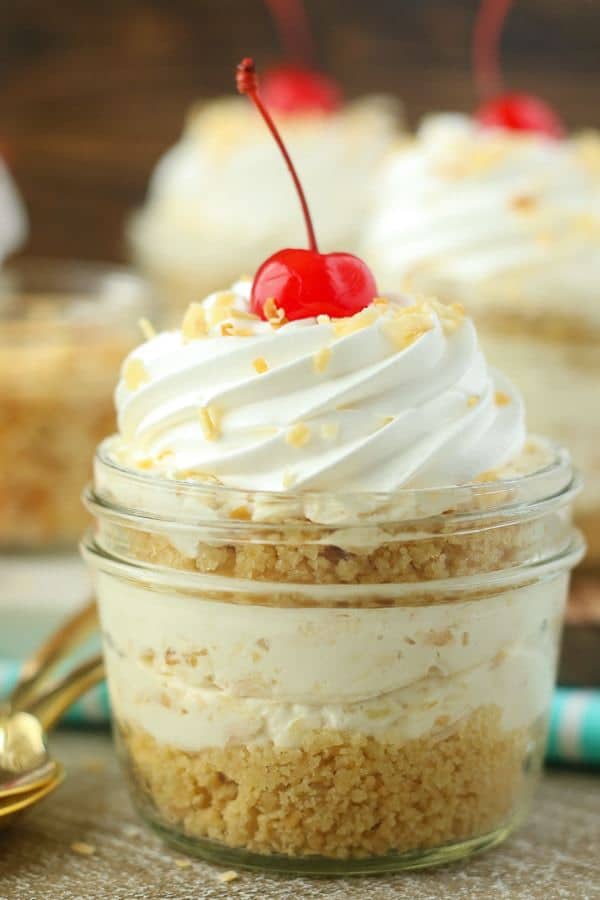 These No-Bake Piña Colada Cheesecake Parfaits are both refreshing and indulgent. These layered cheesecake parfaits start with a buttery Oreo cookie crust. The creamy pineapple coconut cheesecake filling has a hint of rum.