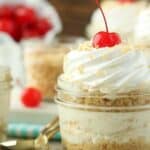 These No-Bake Piña Colada Cheesecake Parfaits are both refreshing and indulgent. These layered cheesecake parfaits start with a buttery Oreo cookie crust. The creamy pineapple coconut cheesecake filling has a hint of rum.