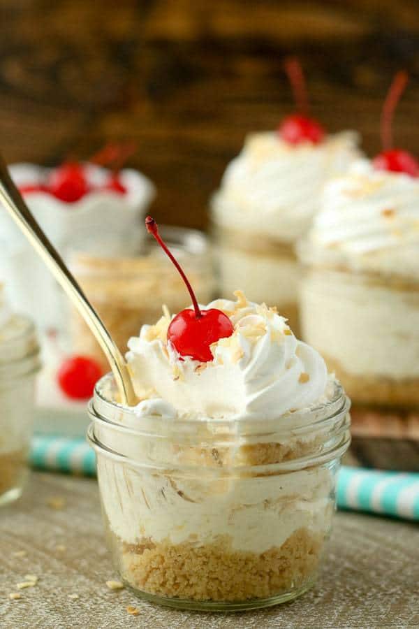 Grab a spoon and dig into these No-Bake Piña Colada Cheesecake Parfaits. These layers parfaits have a golden Oreo cookie crust, a creamy pineapple coconut cheesecake filling and a whipped cream topping.