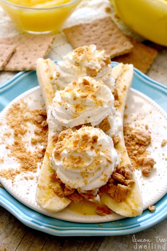 Two Skinny Banana Cream Pie Boats Topped with Whipped Cream on a Teal Plate