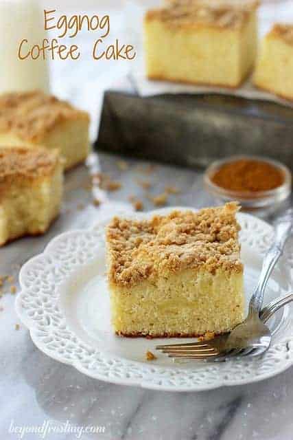 A slice of Eggnog Coffee Cake with a crumbly brown sugar streusel on top resting next to a silver fork.
