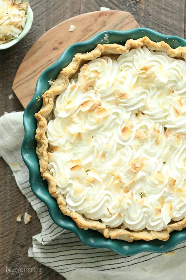 This classic Coconut Cream Pie is made with a sweet coconut custard filled with shredded coconut and it’s topped with fresh whipped cream.