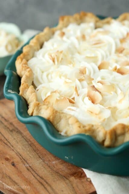 This to-die-for Coconut Cream Pie has a dreamy homemade, sweet coconut custard filling and it’s topped with plenty of whipped cream. It sits in a classic flaky pie crust.